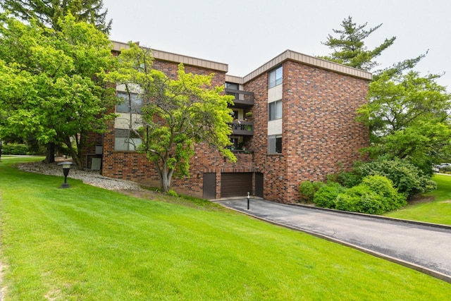 2260 W Good Hope Rd Unit 129, Glendale, WI 53209 - view of property with a garage and asphalt driveway