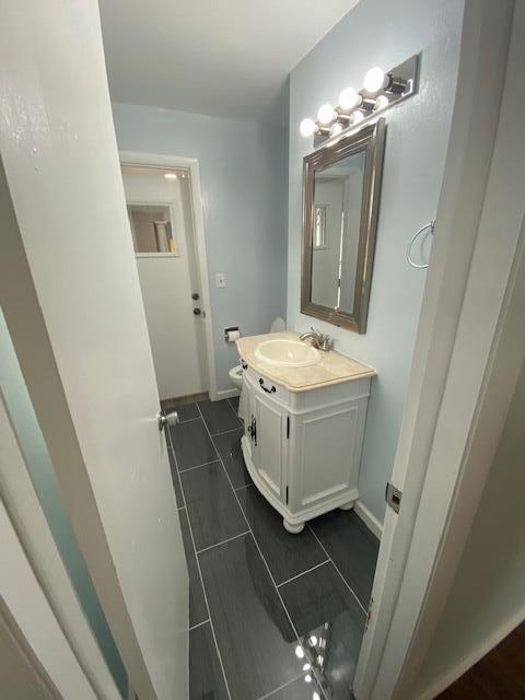 4265 S Nicholson Ave, Saint Francis, WI 53235 - bathroom with vanity, tile patterned floors, and baseboards