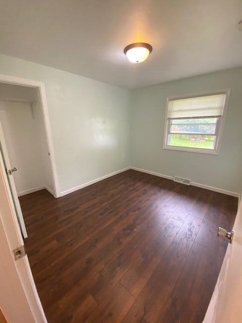 4265 S Nicholson Ave, Saint Francis, WI 53235 - spare room featuring dark wood-style floors and baseboards