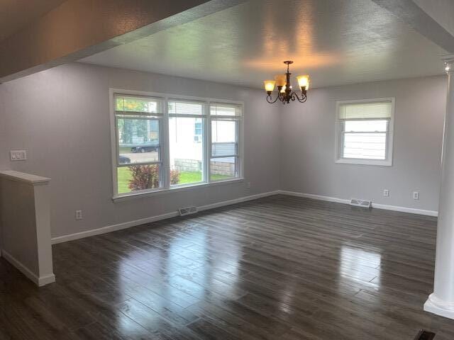 4265 S Nicholson Ave, Saint Francis, WI 53235 - spare room with a chandelier, baseboards, and dark wood finished floors