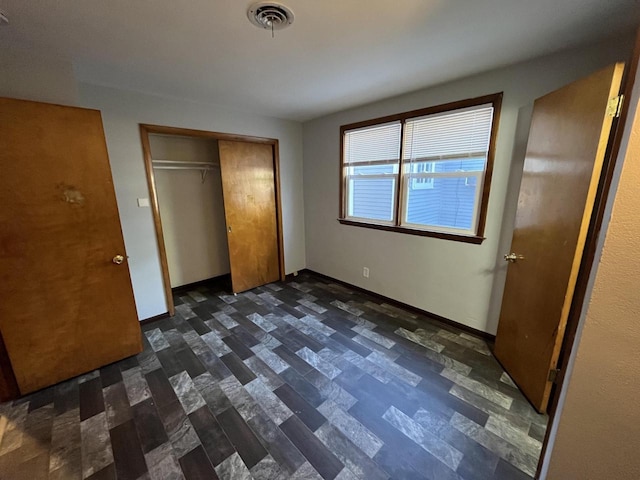 909 College Ave, Racine, WI 53403 - unfurnished bedroom with a closet and baseboards
