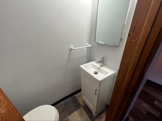 909 College Ave, Racine, WI 53403 - half bath featuring vanity and toilet