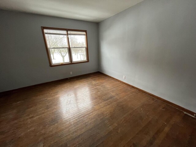 909 College Ave, Racine, WI 53403 - unfurnished room with wood finished floors and baseboards