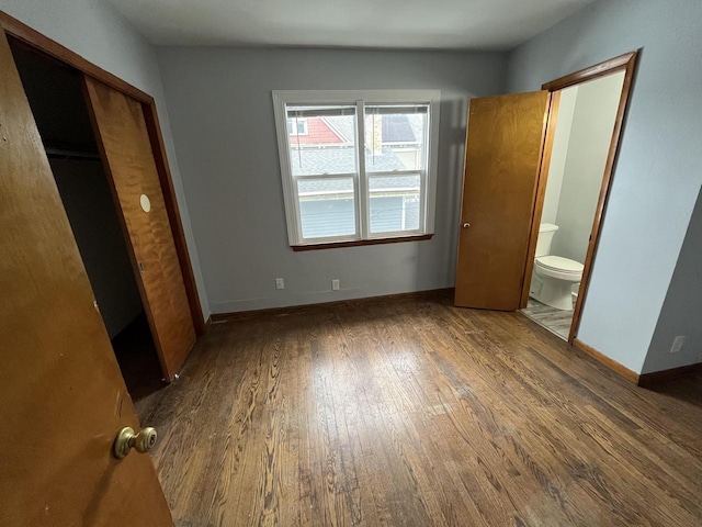 909 College Ave, Racine, WI 53403 - unfurnished bedroom featuring wood finished floors and ensuite bath