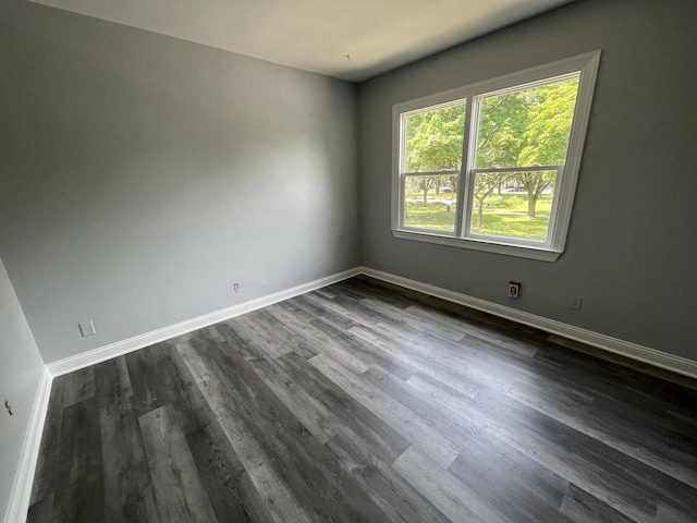 909 College Ave, Racine, WI 53403 - empty room with baseboards and dark wood-style floors