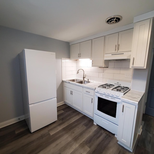 909 College Ave, Racine, WI 53403 - kitchen featuring white appliances, under cabinet range hood, backsplash, dark wood finished floors, and white cabinetry