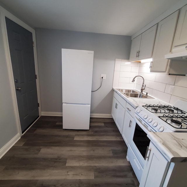909 College Ave, Racine, WI 53403 - kitchen featuring white appliances, dark wood-style floors, tasteful backsplash, white cabinets, and under cabinet range hood