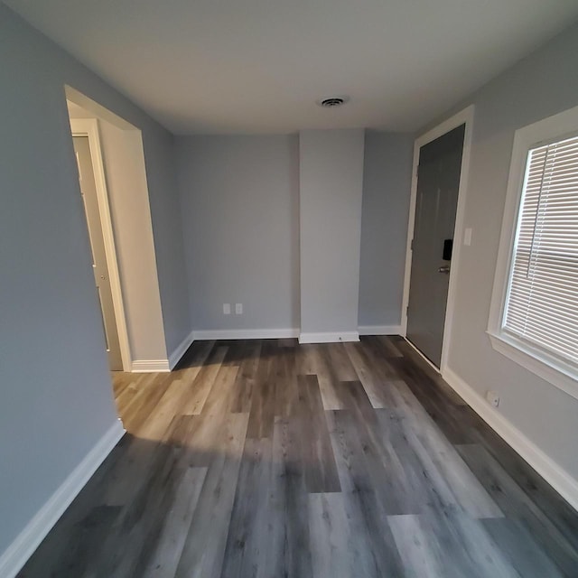 909 College Ave, Racine, WI 53403 - unfurnished room featuring dark wood finished floors and baseboards