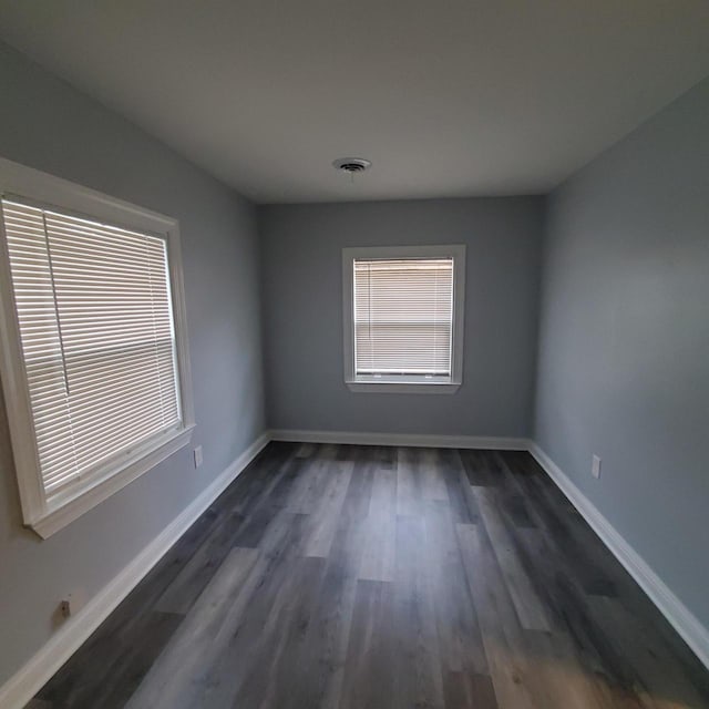 909 College Ave, Racine, WI 53403 - unfurnished room with healthy amount of natural light and dark wood-type flooring