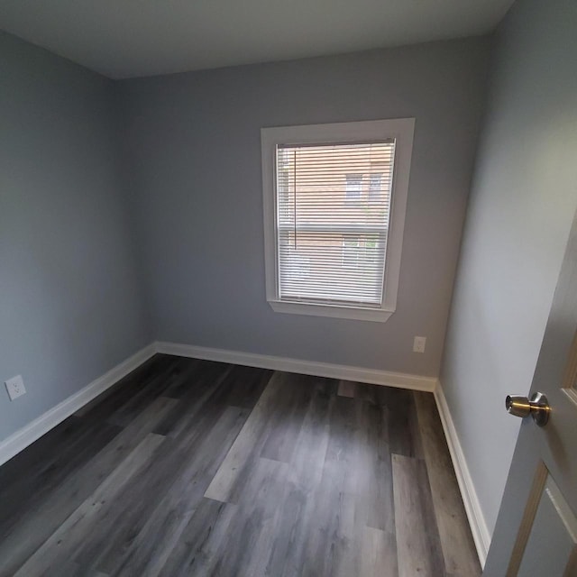 909 College Ave, Racine, WI 53403 - unfurnished room featuring dark wood-style flooring and baseboards