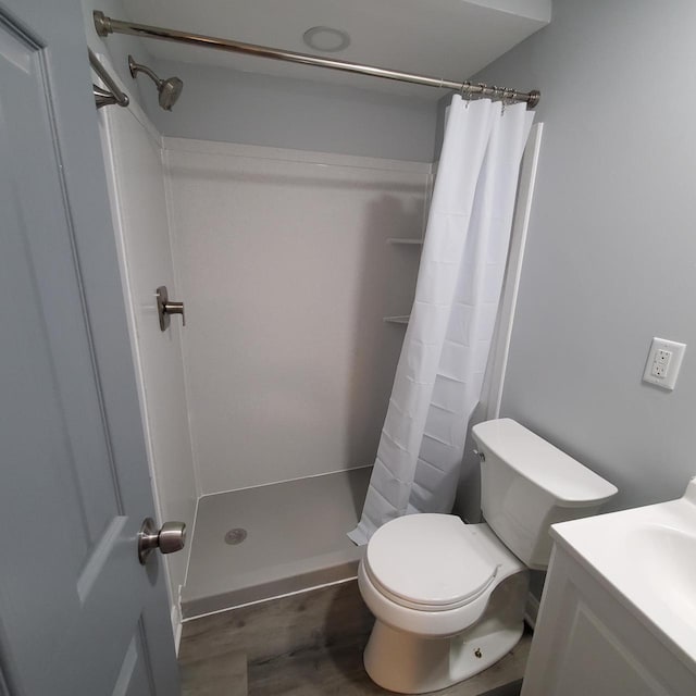 909 College Ave, Racine, WI 53403 - bathroom with vanity, a shower with shower curtain, and wood finished floors