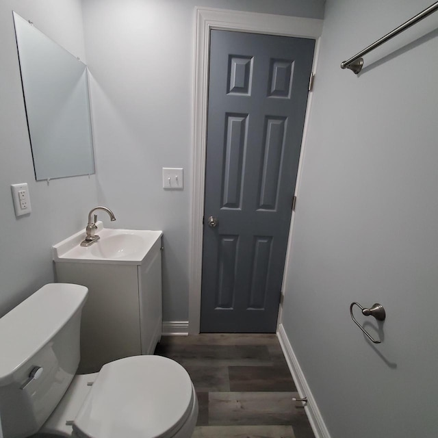 909 College Ave, Racine, WI 53403 - half bathroom with vanity and wood finished floors
