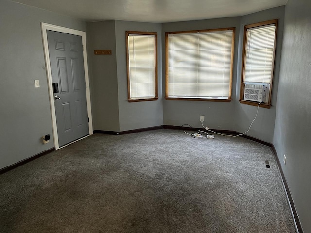 909 College Ave, Racine, WI 53403 - carpeted empty room with cooling unit and baseboards