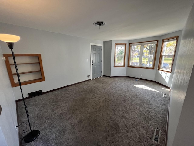 909 College Ave, Racine, WI 53403 - carpeted empty room with baseboards