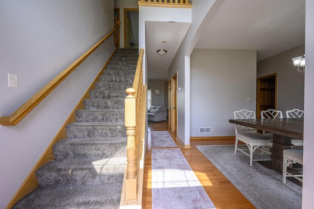 5278 W Highlands Ct, Franklin, WI 53132 - stairway with wood finished floors, arched walkways, and baseboards