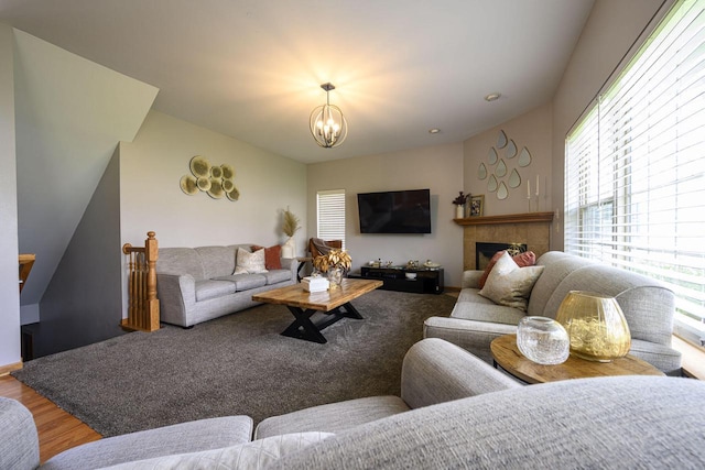 5278 W Highlands Ct, Franklin, WI 53132 - living area with healthy amount of natural light, a chandelier, a tile fireplace, and wood finished floors