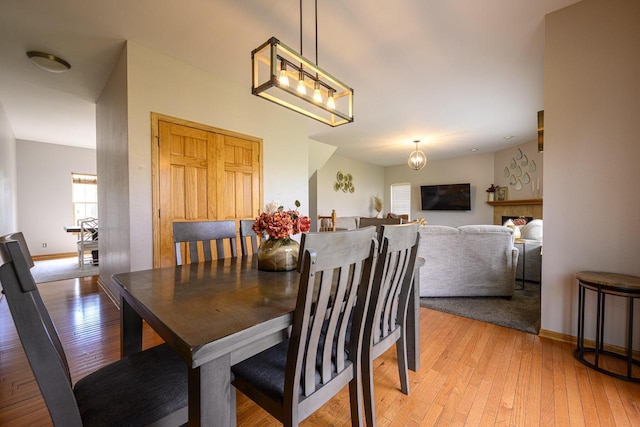 5278 W Highlands Ct, Franklin, WI 53132 - dining room featuring light wood finished floors, baseboards, and a chandelier