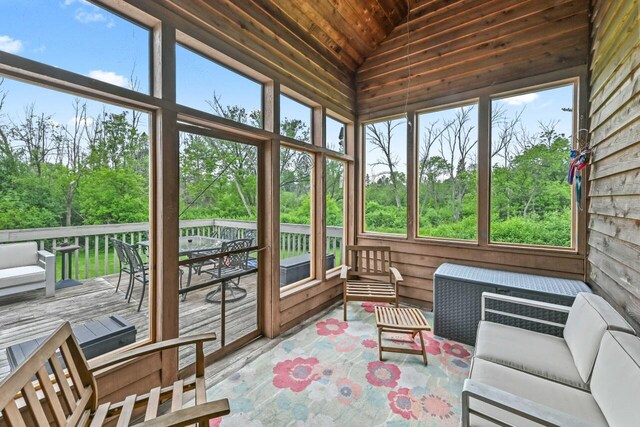 1441 W County Line Rd, River Hills, WI 53217 - sunroom / solarium featuring lofted ceiling, healthy amount of natural light, outdoor lounge area, and view of wooded area