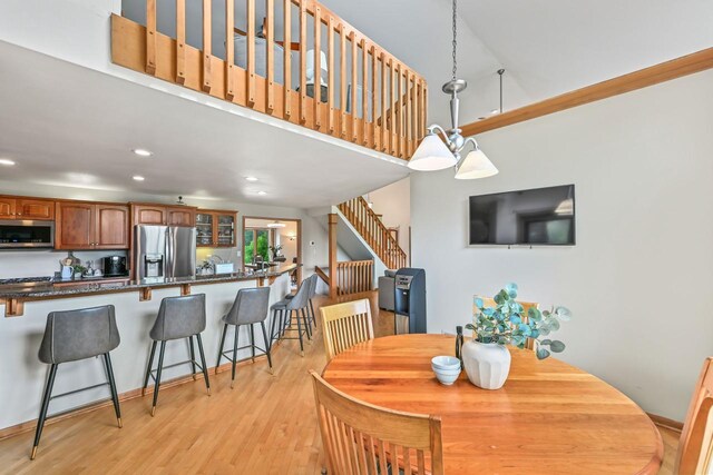 1441 W County Line Rd, River Hills, WI 53217 - dining area featuring a high ceiling, light wood finished floors, stairway, and recessed lighting