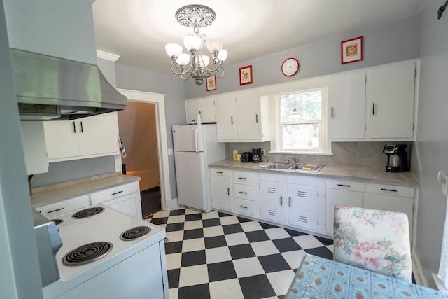 643 Park Ave, Beloit, WI 53511 - kitchen with white appliances, a sink, wall chimney range hood, light flooring, and a chandelier