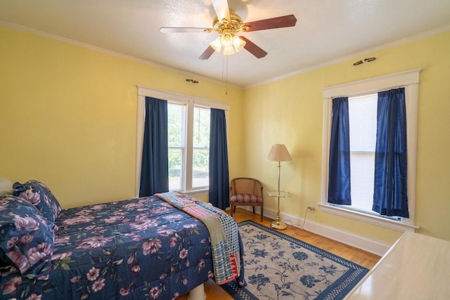 643 Park Ave, Beloit, WI 53511 - bedroom with wood finished floors, baseboards, crown molding, and ceiling fan