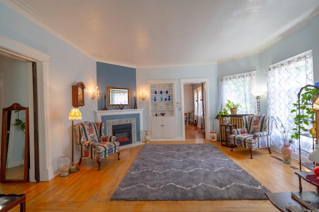 643 Park Ave, Beloit, WI 53511 - living area with a fireplace with flush hearth, healthy amount of natural light, crown molding, and wood finished floors