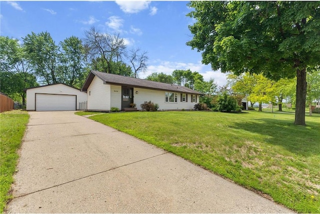 8499 Heron Ave, Cottage Grove, MN 55016 - ranch-style home featuring an outbuilding, a detached garage, and a front lawn