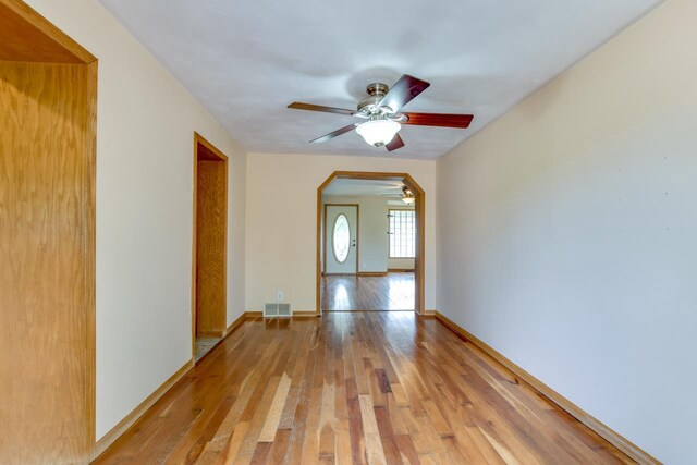 412 High St, Arena, WI 53503 - spare room featuring ceiling fan, light wood-style flooring, and arched walkways