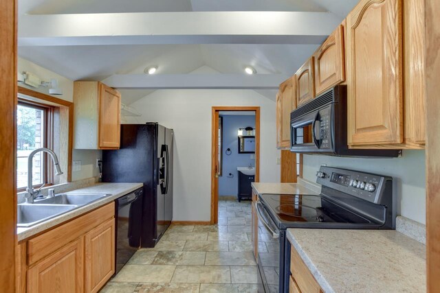 412 High St, Arena, WI 53503 - kitchen with black appliances, vaulted ceiling, light countertops, and light stone finish floors