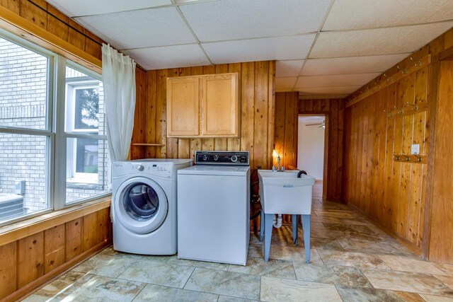 412 High St, Arena, WI 53503 - laundry room featuring wood walls, healthy amount of natural light, and washer and clothes dryer