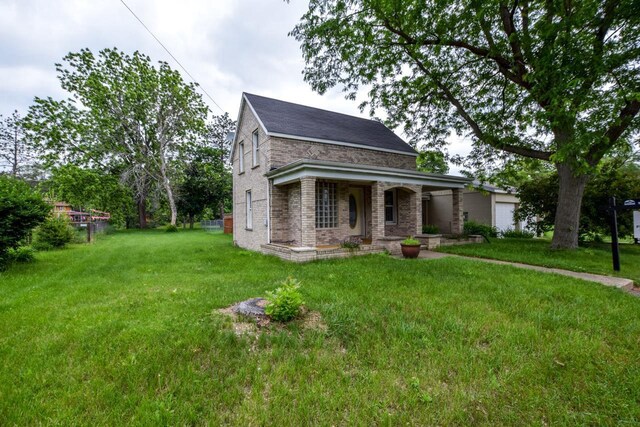 412 High St, Arena, WI 53503 - view of front of home with brick siding, a front yard, an attached garage, and a porch