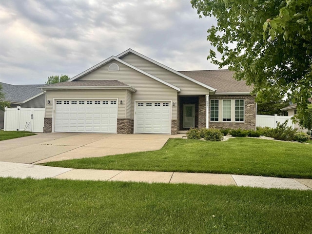 4017 Sandhill Dr, Janesville, WI 53546 - ranch-style house featuring brick siding, a garage, driveway, a gate, and a shingled roof