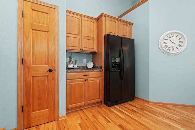 4017 Sandhill Dr, Janesville, WI 53546 - kitchen featuring black fridge with ice dispenser, light wood-type flooring, and dark countertops