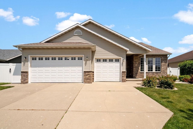 4017 Sandhill Dr, Janesville, WI 53546 - view of front of house with brick siding, an attached garage, and driveway