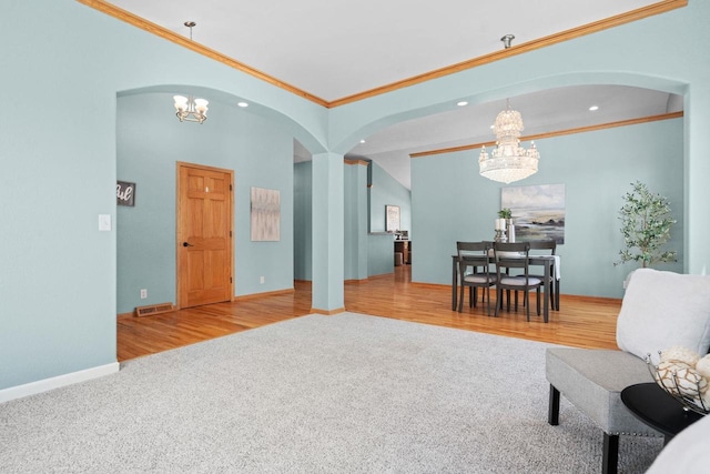 4017 Sandhill Dr, Janesville, WI 53546 - carpeted living area with arched walkways, a chandelier, ornamental molding, and recessed lighting