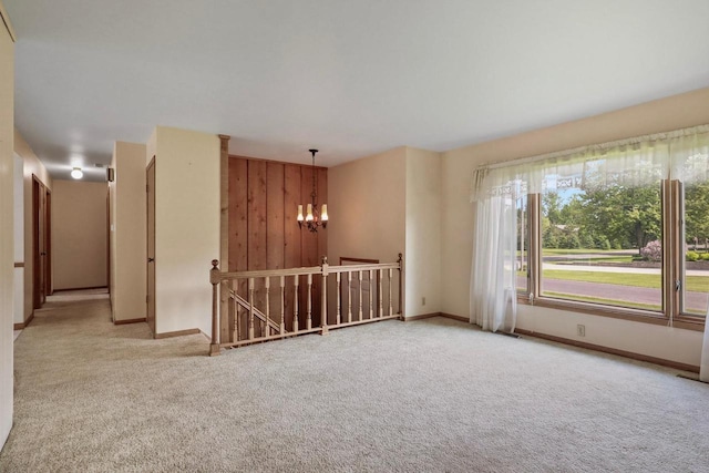 6521 Batavia Ave, Wisconsin Rapids, WI 54494 - unfurnished room featuring a chandelier, carpet flooring, and baseboards