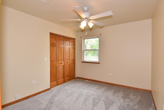 6023 241st Ave, Salem, WI 53168 - unfurnished bedroom with light carpet, baseboards, a closet, and ceiling fan