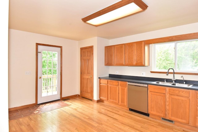 6023 241st Ave, Salem, WI 53168 - kitchen with dishwasher, a sink, dark countertops, light wood-style flooring, and baseboards