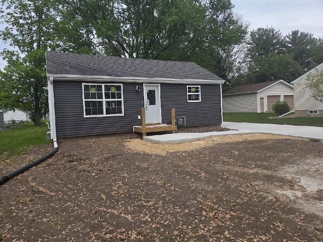 524 Charles St, Reedsburg, WI 53959 - view of front of home featuring an outdoor structure and roof with shingles
