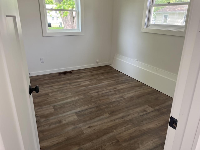 524 Charles St, Reedsburg, WI 53959 - spare room featuring dark wood-style floors and baseboards