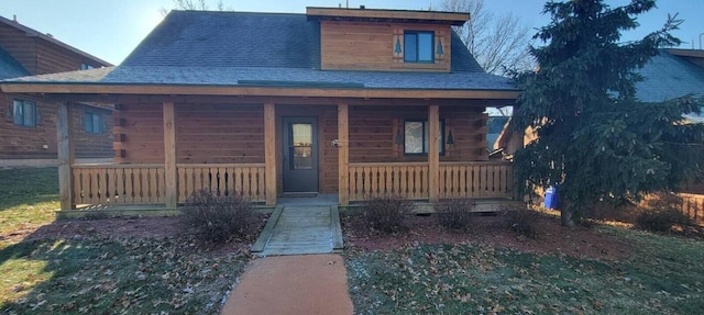 716 Skatepark Ct, Warrens, WI 54666 - log home with covered porch and a shingled roof