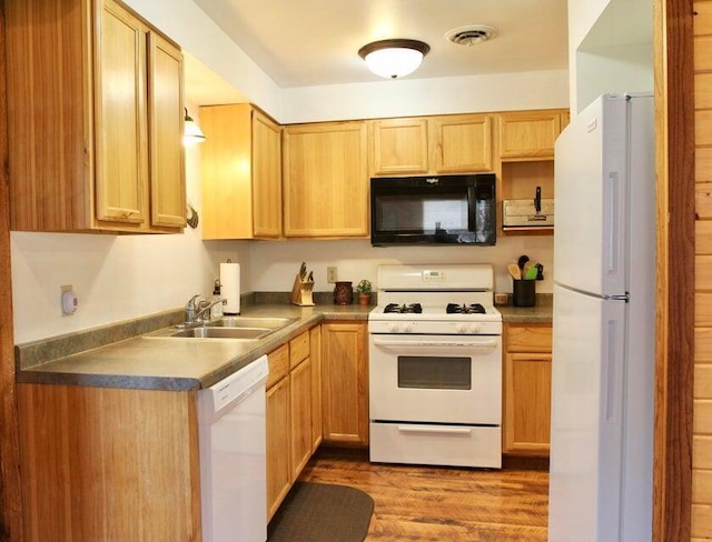 716 Skatepark Ct, Warrens, WI 54666 - kitchen featuring white appliances, a sink, wood finished floors, dark countertops, and light brown cabinetry