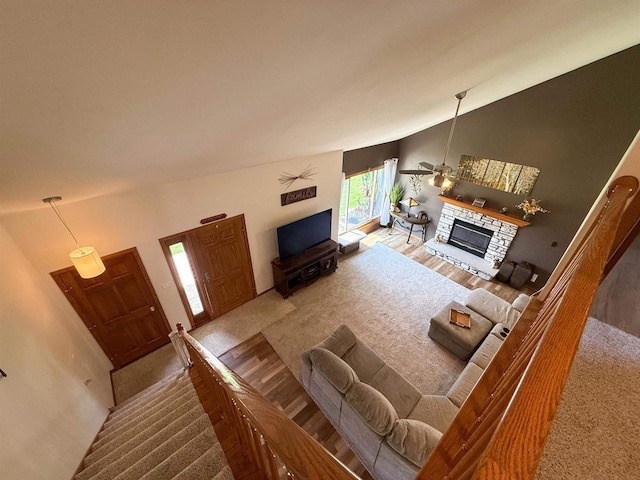 1053 Eastman Ln, Fond Du Lac, WI 54935 - living area featuring lofted ceiling, a fireplace, and wood finished floors