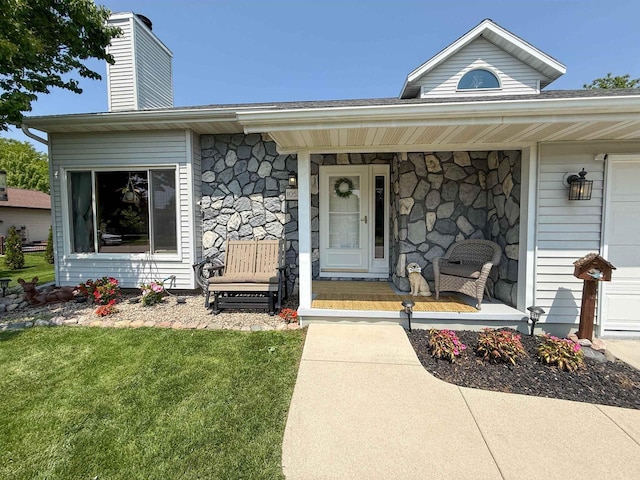 1053 Eastman Ln, Fond Du Lac, WI 54935 - property entrance with a porch, a chimney, stone siding, and a yard
