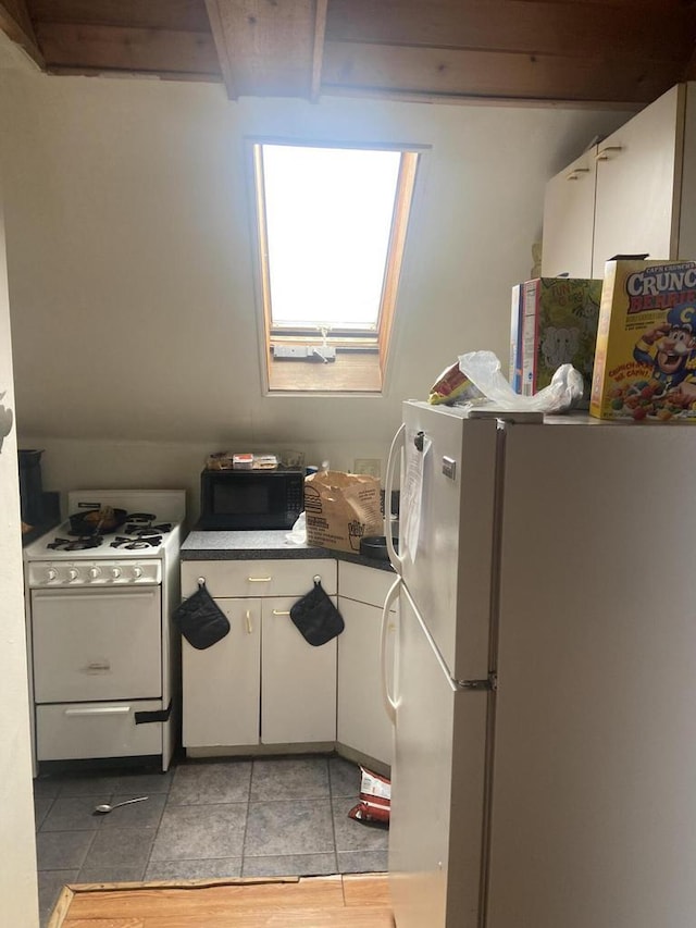 2919 N 50th St Unit 2919A, 2921, Milwaukee, WI 53210 - kitchen with white appliances, white cabinets, dark countertops, and light tile patterned flooring