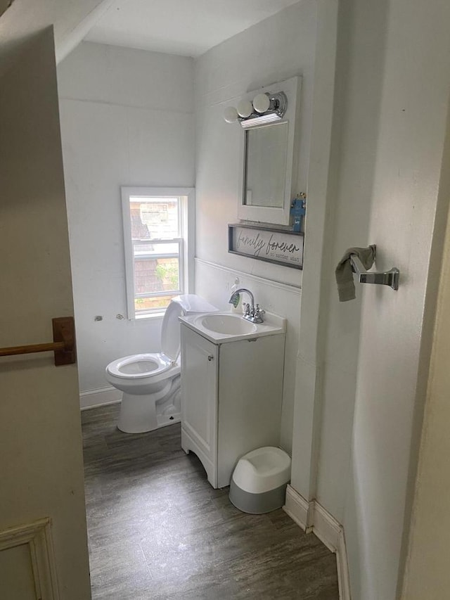 2919 N 50th St Unit 2919A, 2921, Milwaukee, WI 53210 - half bathroom with toilet, vanity, and wood finished floors