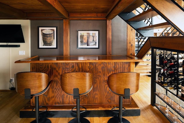 1545 Arboretum Dr Unit 315, Oshkosh, WI 54901 - indoor dry bar featuring hardwood / wood-style flooring, wooden ceiling with exposed beams, stairs, and baseboards