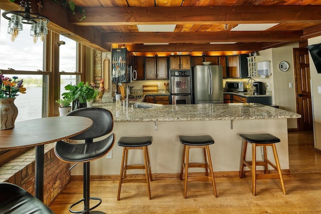 1545 Arboretum Dr Unit 315, Oshkosh, WI 54901 - kitchen with stainless steel appliances, a peninsula, wooden ceiling with exposed beams, a sink, and light wood-style floors