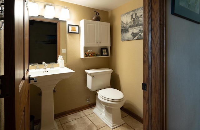 1545 Arboretum Dr Unit 315, Oshkosh, WI 54901 - half bathroom with toilet, tile patterned flooring, and baseboards
