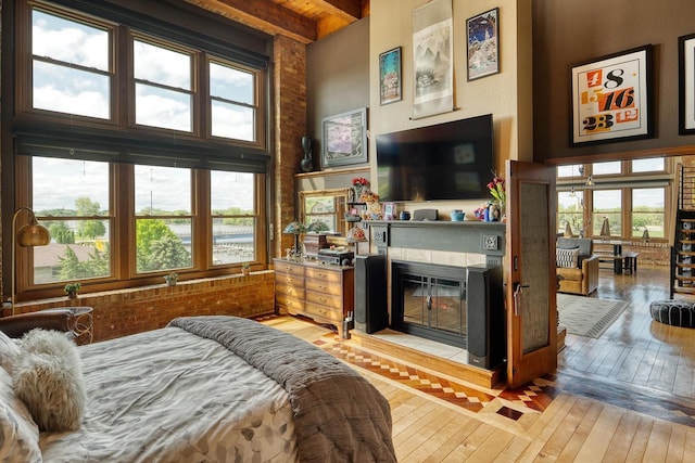 1545 Arboretum Dr Unit 315, Oshkosh, WI 54901 - bedroom with light wood-style floors, a glass covered fireplace, and beam ceiling